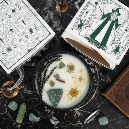 Bougie cristal menthe avec pierres de jade et fleurs, présentée avec son emballage Magician et accessoires mystiques.