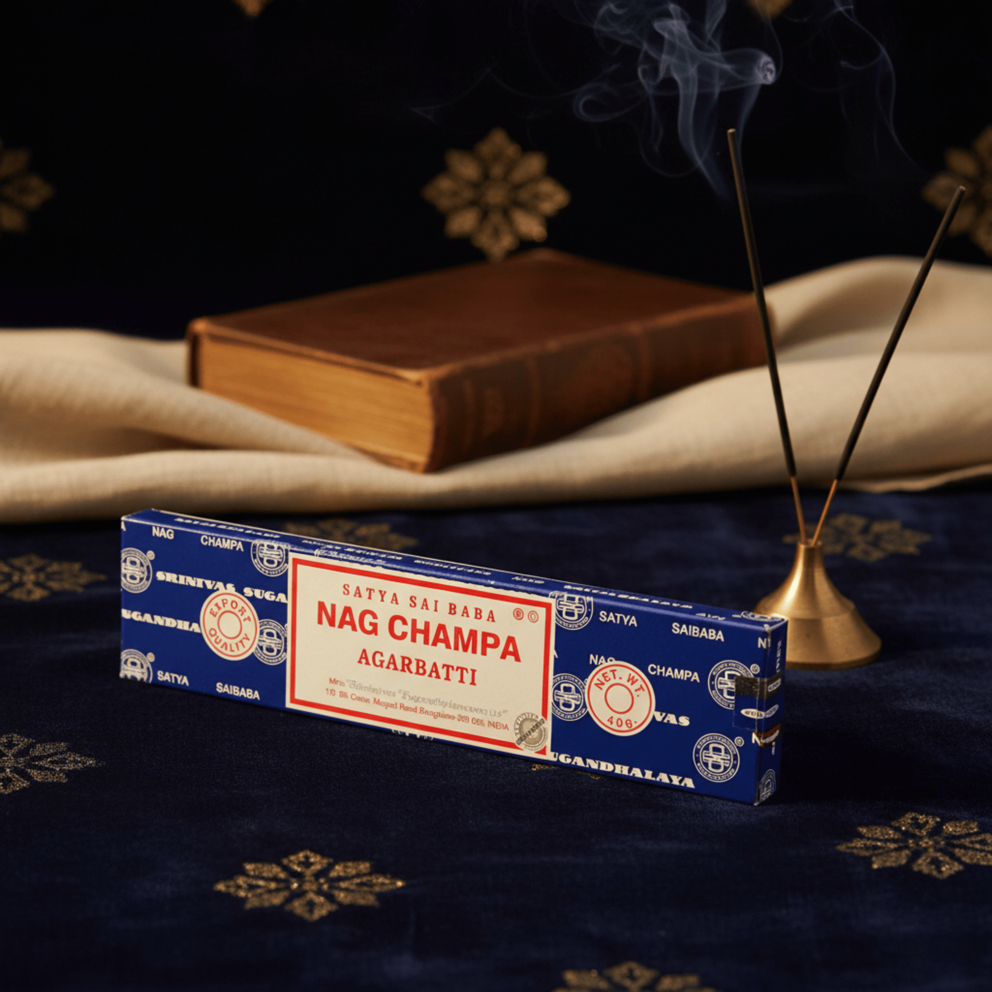 Encens Nag Champa Agarbatti sur tissu bleu, fumée d’encens et décor oriental, parfum sacré idéal pour méditation et rituels.